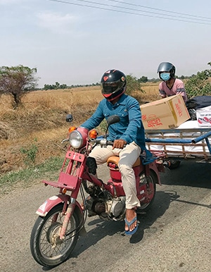 Delivering food on a motorcycle with trailer