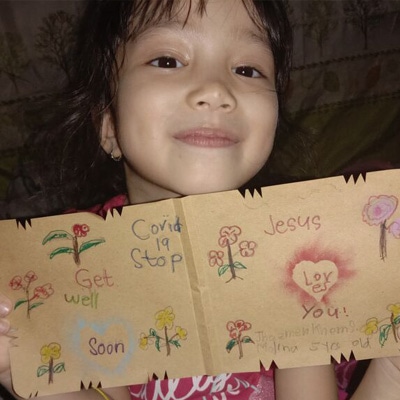 A child holding get well card