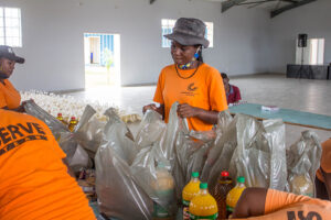 Child Champions pack food to help families in Zimbabwe feed their children.