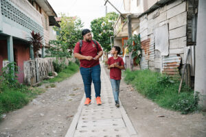 A Hope Center director walks through a rough neighboohood with one of the boys who attends his Hope Center