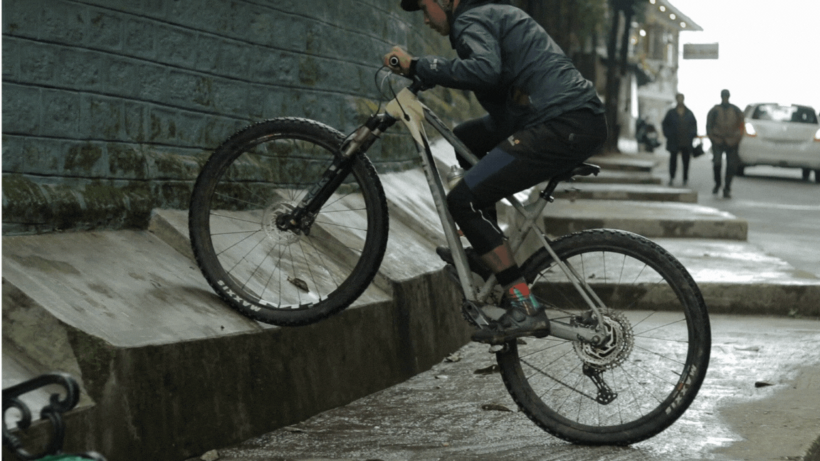 A boy practices mountain bike tricks