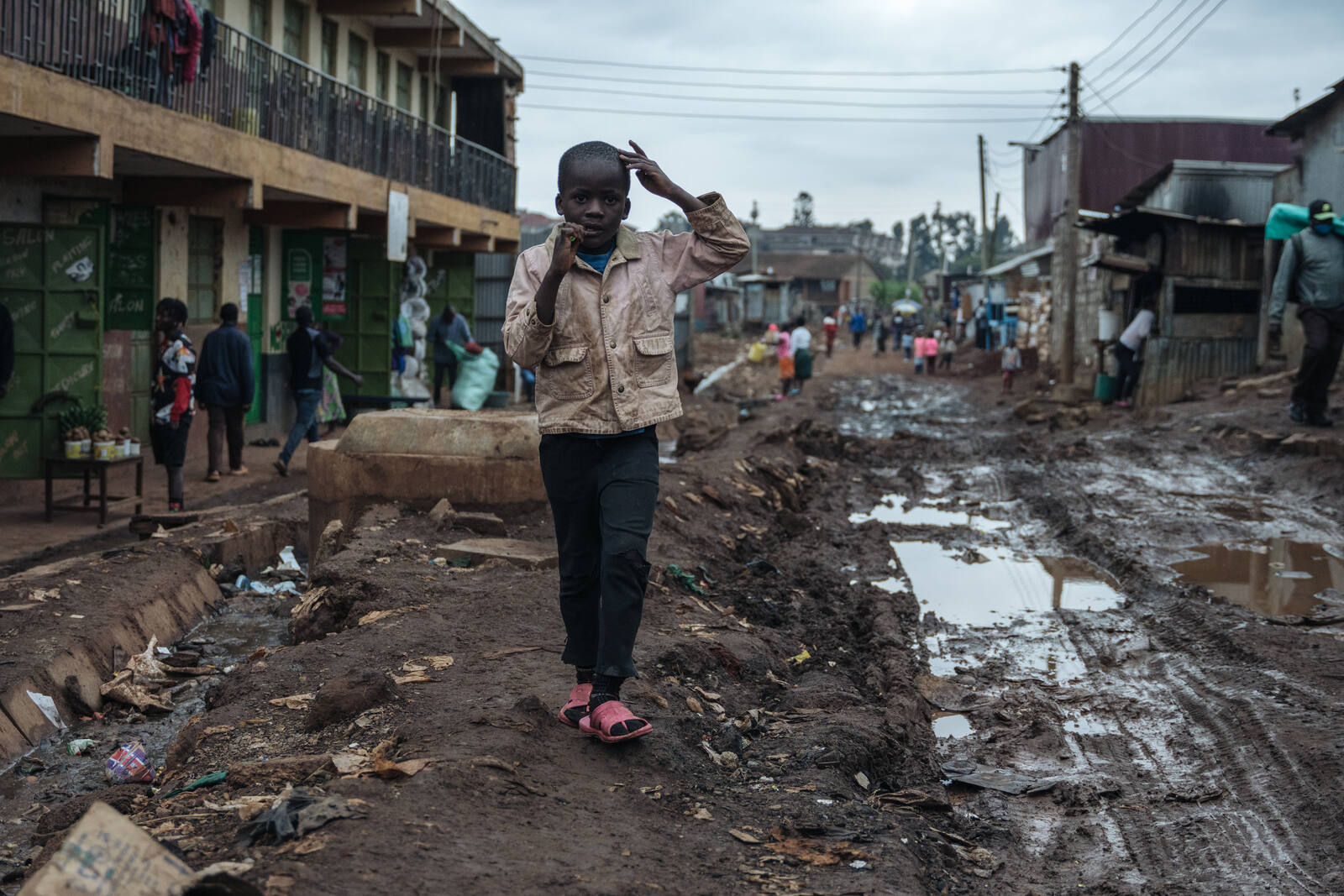 A boy walking through his community in Nairobi